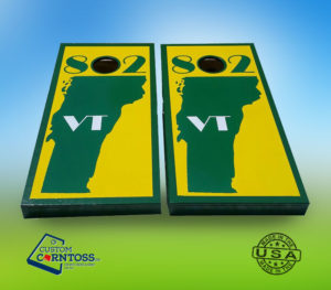 Cornhole boards with yellow and green Vermont flag pattern